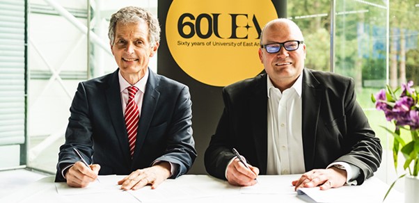 Prof David Maguire, Vice Chancellor of the University of East Anglia, and Darren Henley CBE, Chief Executive of Arts Council England, sitting together after signing a new agreement to boost creativity, research, and cultural activities in Norfolk