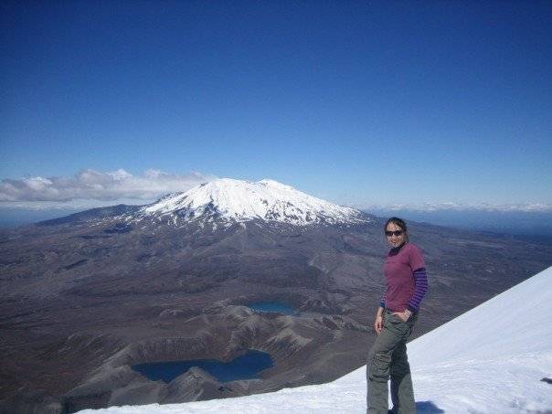 Dr Jess Johnson atop Mount Ngauruhoe volcano (Mount Doom) with a view of Mount Ruapehu in New Zealand