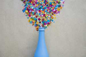 spangles scattered from blue bottle grey table