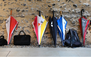 umbrellas stacked against a wall