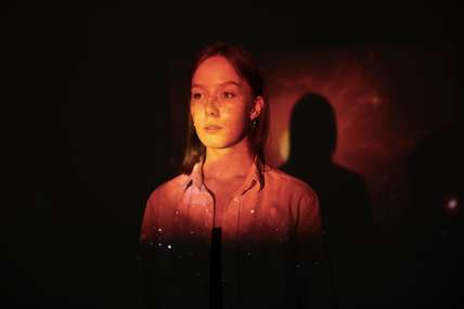 young-woman-standing-universe-texture-projection