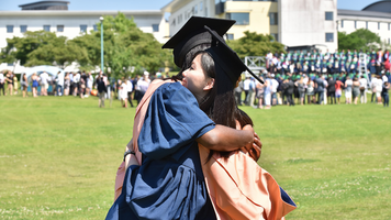 Graduates hugging