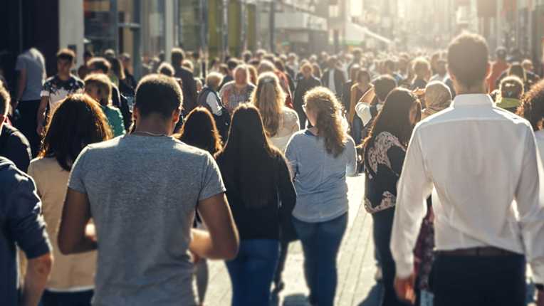 Picture of a crowd of people walking through street