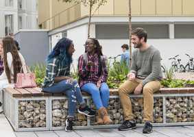 students socialising outside accommodation on campus