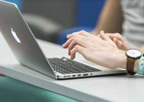 Typing on a laptop