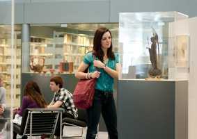 student looking at exhibition in Sainsbury Centre