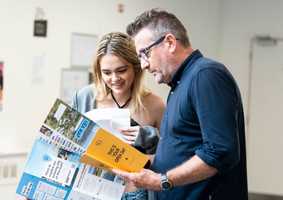 parent and student looking at a leaflet at an open day