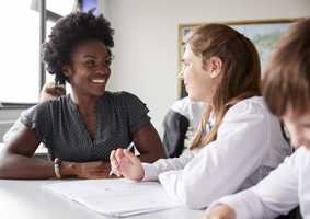 PGCE Female tutor helping student with school work