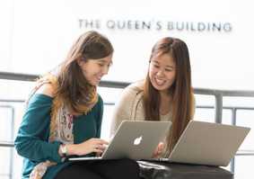 Two students with laptops