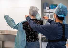 participant putting on a medical apron