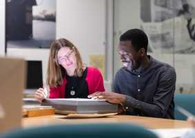 two people reviewing archive material