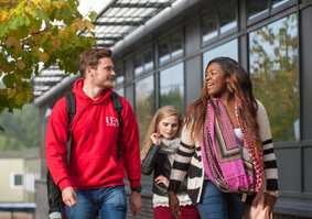 student walking past building chatting
