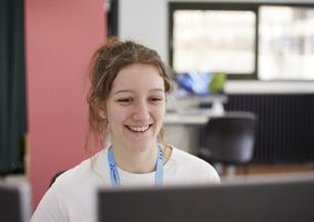 featured_jobs_staff_smiling_at_computer.jpg