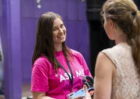 Smiley student wearing an 'ask me' t-shirt