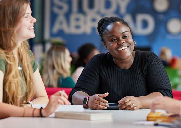 students smiling in Study Abroad office