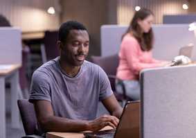 postgraduate student working on laptop