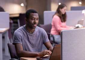 postgraduate student working on laptop