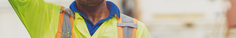 Man in hi-vis clothing wiping away sweat
