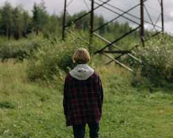 teenager walking in a field