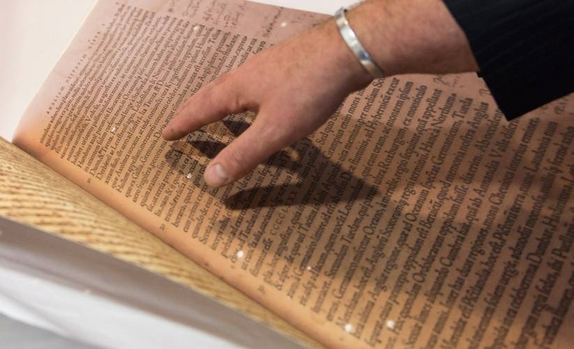 Man pointing at a historic book