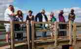 A group meets on the bridge at Burgh Castle