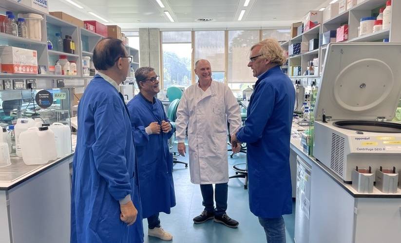 Dr KeeWee Tan and Omar Alattas speaking with Dr Jeremy Clark and Professor Cooper in the Bob Champion Research and Education Building.