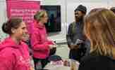 People talking at a Development Employability Week stand