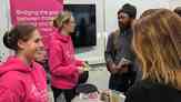 People talking at a Development Employability Week stand