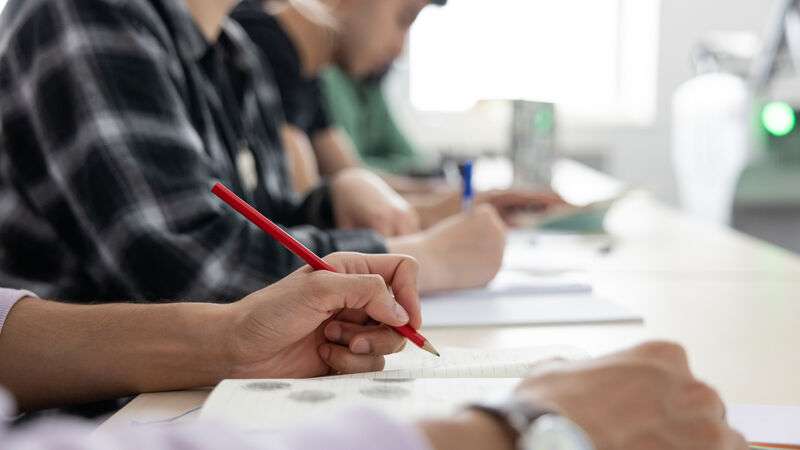An image of a students hands writing