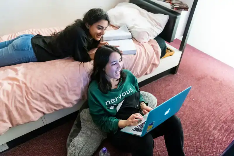Students in accommodation on laptop