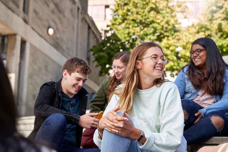 students smiling in UEA square