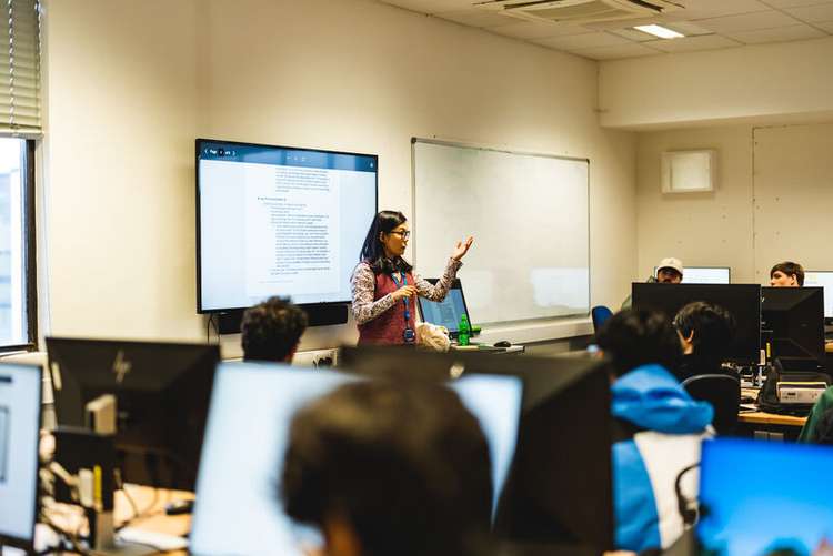 Lecturer teaching students in a computing science lab