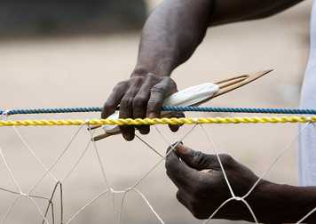 DEV_person_repairing_fishing_nets.jpg