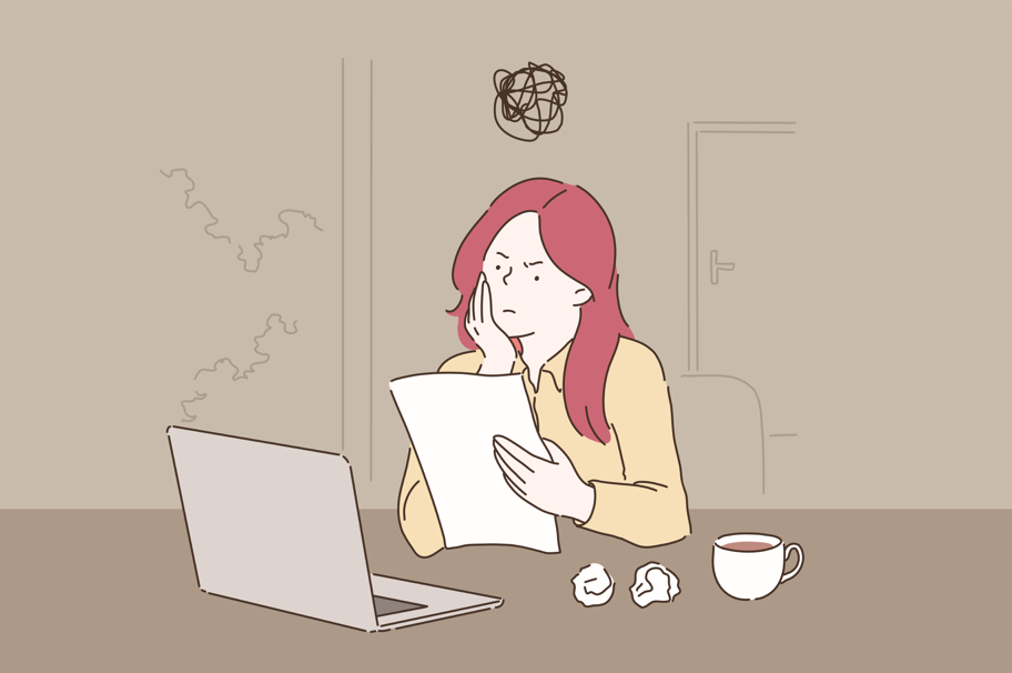 confused woman looking at paperwork sitting in front of computer